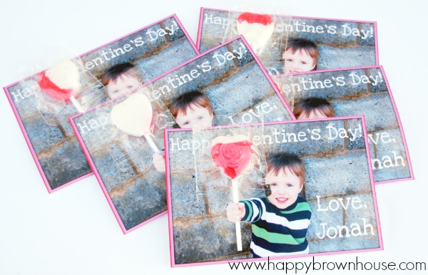 Are you looking for an easy DIY valentines for kids that are inexpensive and quick to put together? These DIY Lollipop Valentines are super cute and a cinch to pull together. The thing that took the most time for me was waiting on the pictures to print, so I could assemble these homemade picture valentines cards for kids. Grab your camera and your favorite little cupid to make these for his or her Valentine's Day class party.