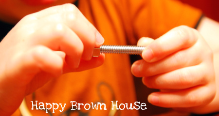 Twisting nuts and bolts~fine motor skills @happybrownhouse www.happybrownhouse.com