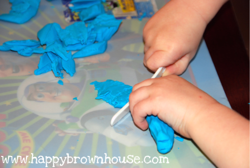 Cutting Playdough with plastic knives