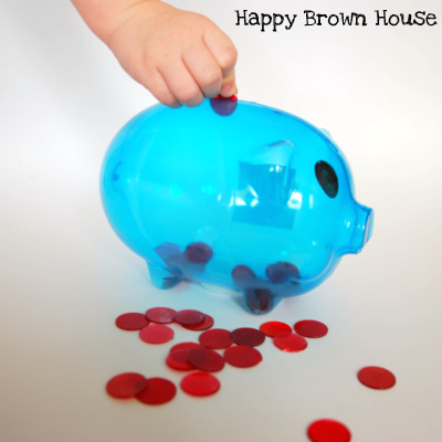 Piggy Bank Fine Motor Skills practice from @happybrownhouse www.happybrownhouse.com