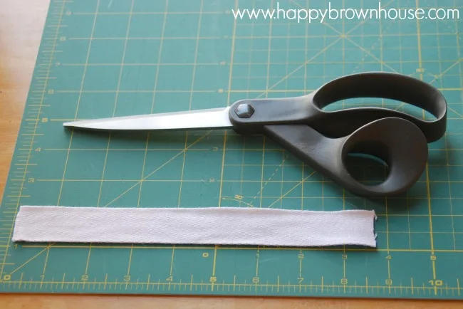 use twill tape to make a loop for the DIY plastic bag holder