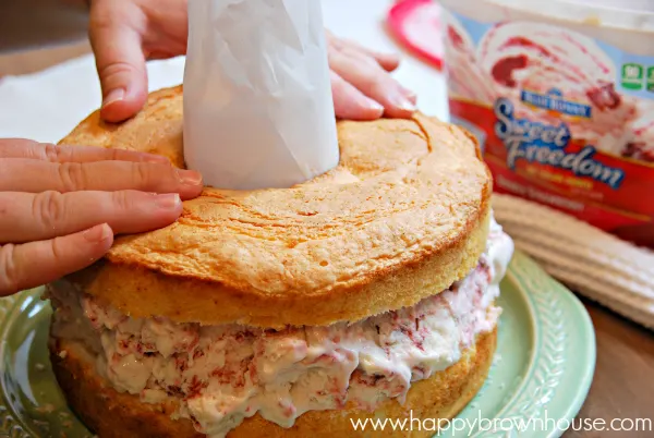 cutting angel food cake for Strawberry Shortcake Ice Cream Cake