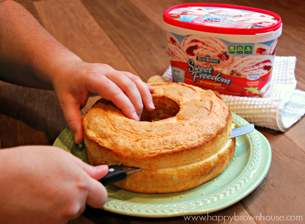 cutting angel food cake for Strawberry Shortcake Ice Cream Cake