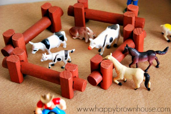 corral for small world play made out of Lincoln Logs