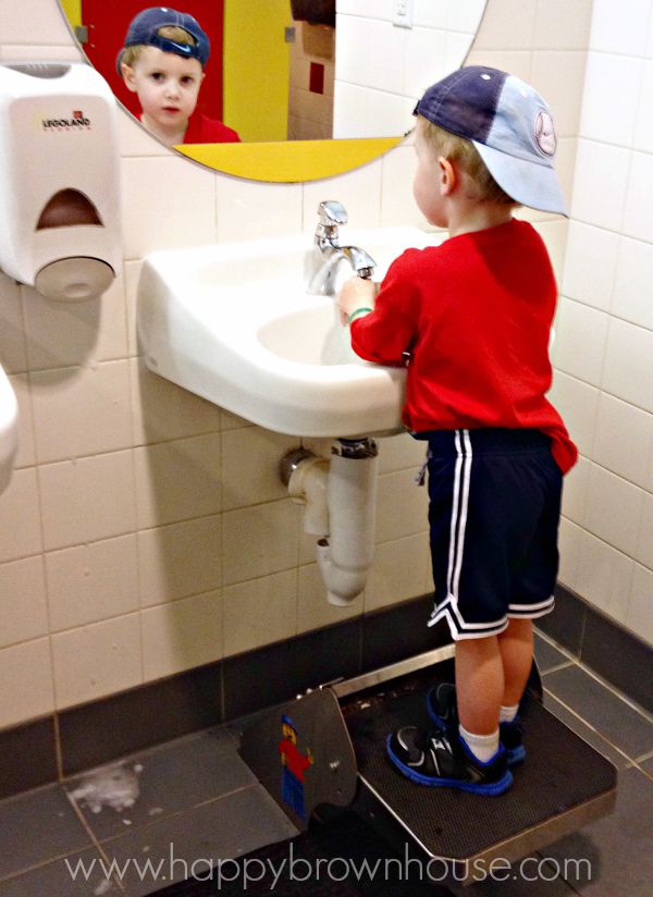 Legoland bathrooms have stools to help kids reach the sink and build independence