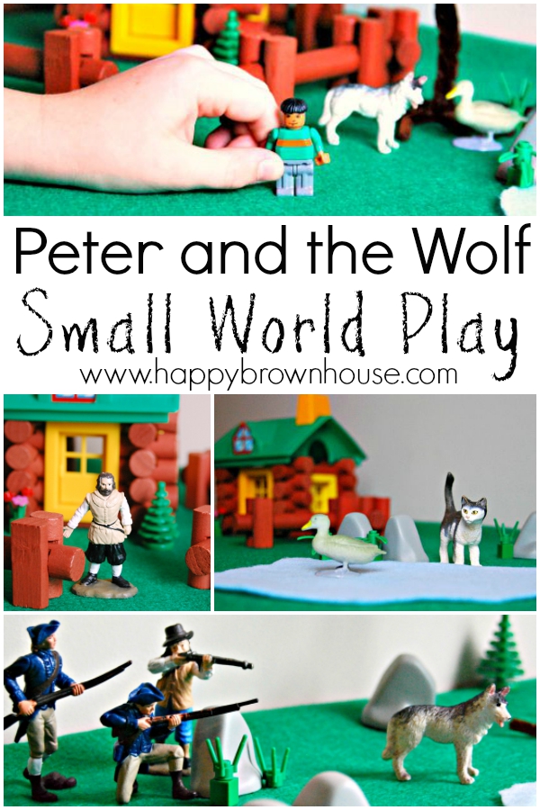 Child\'s hand playing with miniature toy person figurine. Log toy house, pipe cleaner tree, and animal toy figurines in the background. This children\'s activity is a Peter and the Wolf small world play activity for acting out the classical musical story.