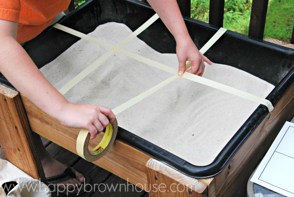 Making an archaeology grid on a sand table for archaeologist pretend play