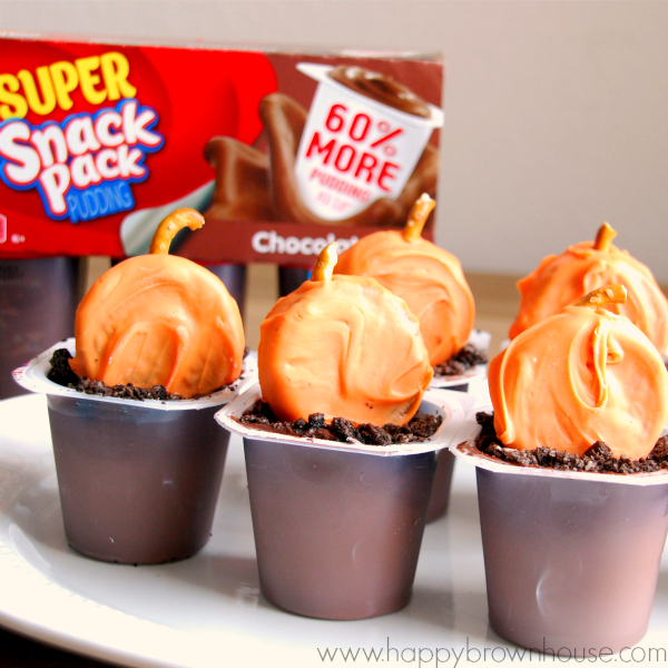 Snack Pack Pudding Cups with candy coated OREO pumpkins