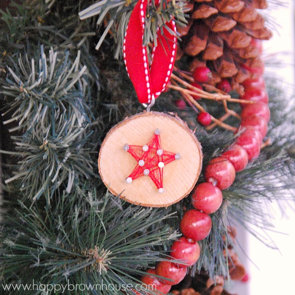 This rustic DIY Wood Slice String Art Ornament is simple to make and looks beautiful on the Christmas tree. Give as a gift or add to the top of a present for a creative giftwrap idea. Inspired by a Christmas children's book, this kid's Christmas ornament is perfect for fine motor skills practice. 