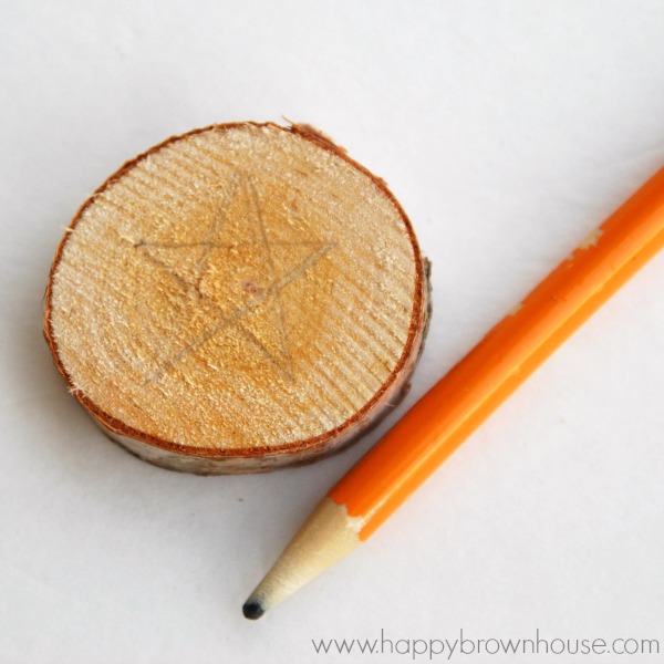 This rustic DIY Wood Slice String Art Ornament is simple to make and looks beautiful on the Christmas tree. Give as a gift or add to the top of a present for a creative giftwrap idea. Inspired by a Christmas children's book, this kid's Christmas ornament is perfect for fine motor skills practice. 