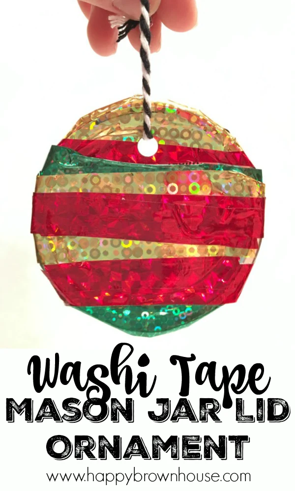 This Kid-Made Washi Tape Mason Jar Lid Ornament is adorable and so simple to make for Christmas. This homemade ornament is perfect for working on fine motor skills. The best part is I already have all the mason jar lids and washi tape for this kids Christmas ornament craft.