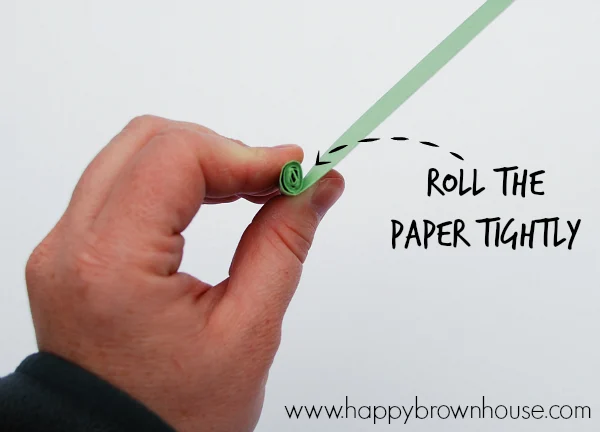 hand rolling a 1 inch paper strip tightly