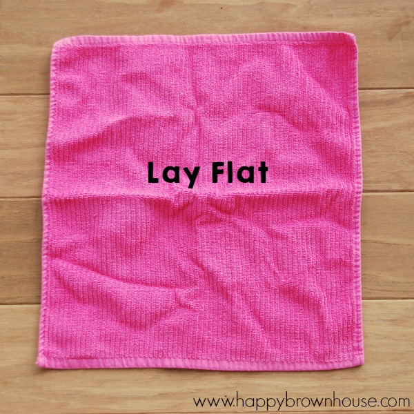 Need help with the laundry? Use this simple trick to teach kids how to fold a washcloth. Give kids independence with folding the laundry with this simple washcloth hack.