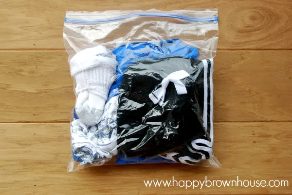 Travel clothes placed in a gallon size storage bag to make trips easier with kids. I love this tip!