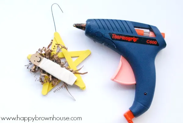 Hot glue an ornament hook to the Nativity Star Ornament Craft for kids