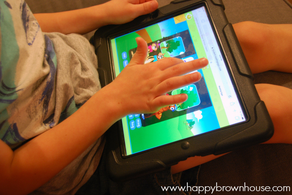 close up of iPad screen and child\'s hands playing the Reading Eggs game