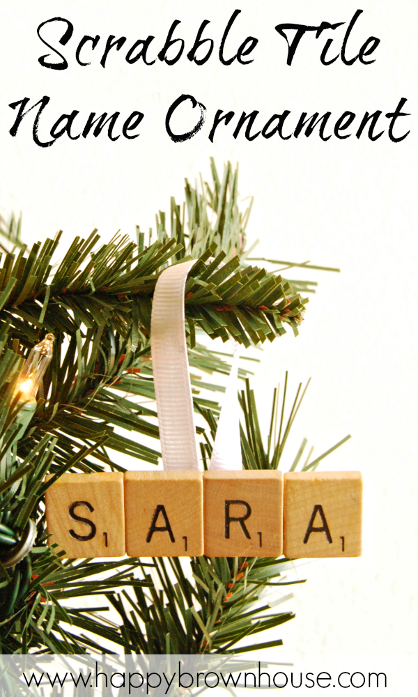 close up of a name ornament made out of recycled scrabble tiles, The Scrabble Tile Name Ornament is hanging on a branch of a Christmas tree