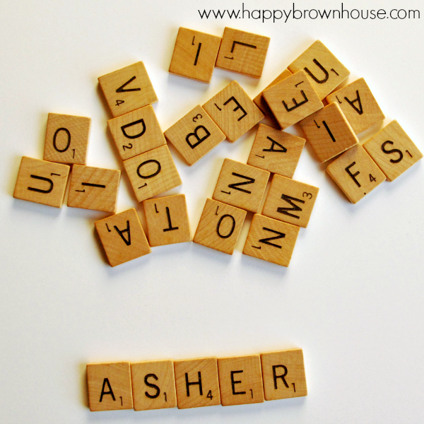 a pile of Recycled scrabble tiles to be made into a  Scrabble Tile Name Christmas Ornament