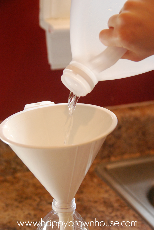 pouring vinegar into a funnel