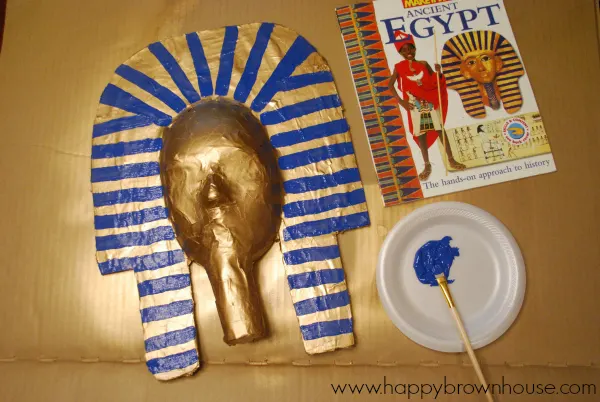 Making a King Tut Burial Mask with kids is a super fun way to finish an Egypt unit study. Kids will love to paper maché and the finished King Tut Mask will be an art project you won't mind keeping on display. #homeschool #kids #craft #kidcraft #ancientegypt #egypt #unitstudy #craftsforkids
