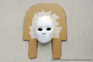 cut cardboard shape and attach mask to prepare for paper mache