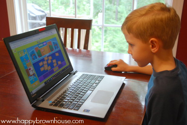 side profile of a little boy playing Reading Eggs on a laptop computer