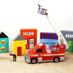 This DIY Wooden Block Town is the perfect homemade gift to accompany your child's favorite rescue vehicles. Kids will love engaging in imaginative play as they pretend to put out fires and rescue the town. See how one mom pairs the town with the PLAYMOBIL Take Along Fire Station and Rescue Ladder Unit for the ultimate pretend play experience. #PlayWithPlaymobil #pretendplay #kids #crafts #kidcrafts #imagination