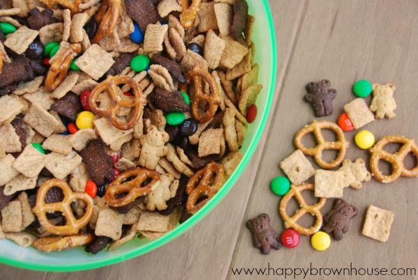 close up of Teddy Bear Trail Mix ingredients in a bowl and scattered on the table