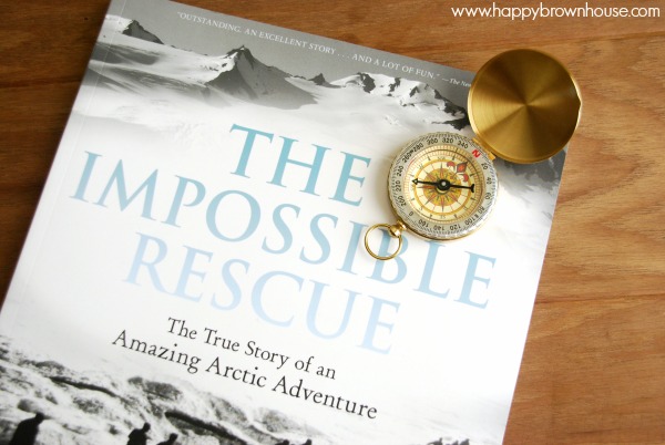 Close up of The Impossible Rescue book and a compass