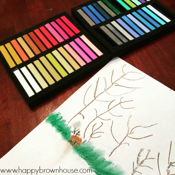 close up of a child\'s drawing on a white piece of paper with a box of rainbow chalk pastel art while using the chalk art drawing tutorials from You Are an Artist