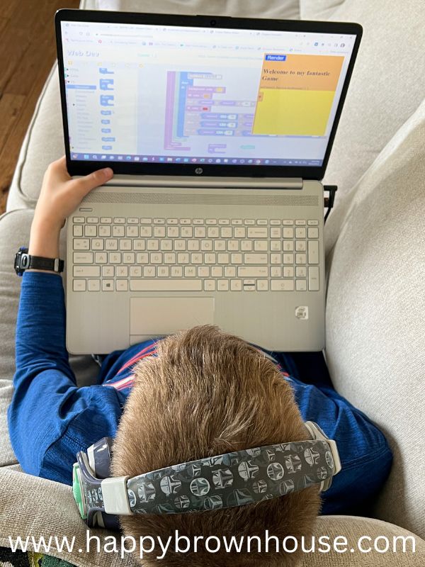 Overhead view of a child looking at a laptop